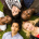 Youth laying on the ground in a circle with their heads toward the middle